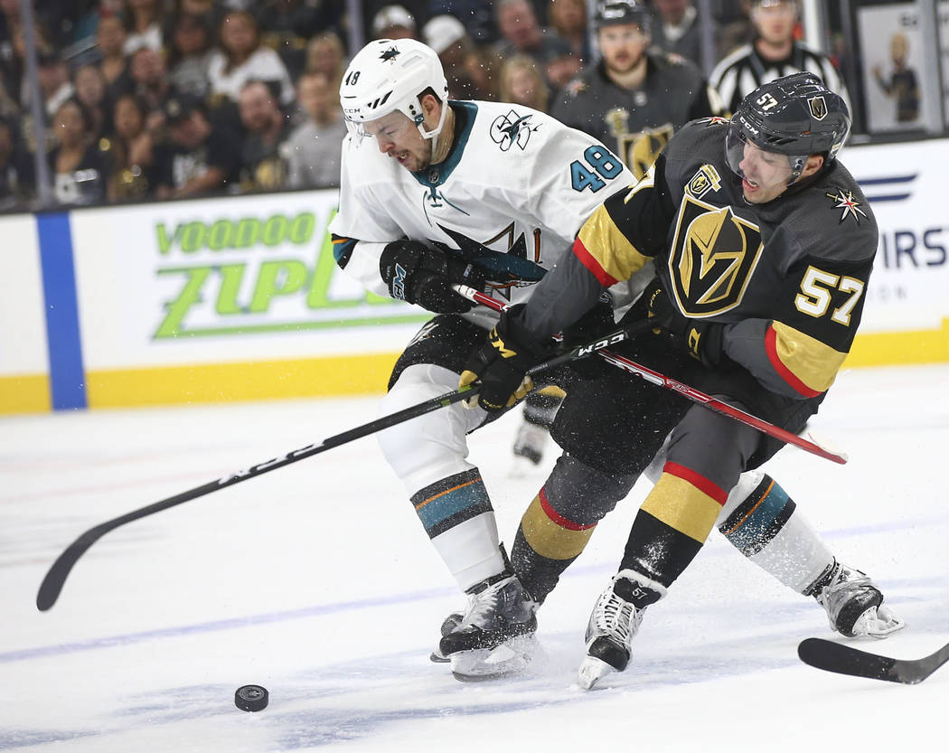 Golden Knights left wing David Perron (57) and San Jose Sharks center Tomas Hertl (48) battle for the puck during the first period of Game 2 of an NHL hockey second-round playoff series at T-Mobil ...