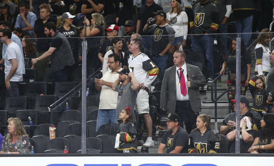 Golden Knights fans react as San Jose Sharks players, not pictured, celebrate their double overtime defeat over the Knights in Game 2 of an NHL hockey second-round playoff series at T-Mobile Arena ...
