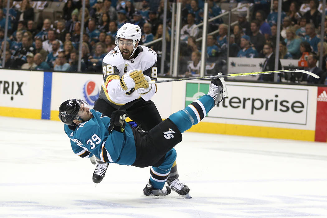 Vegas Golden Knights right wing Alex Tuch (89) knock down San Jose Sharks center Logan Couture (39) during the first period in Game 3 of an NHL hockey second-round playoff series at the SAP Center ...