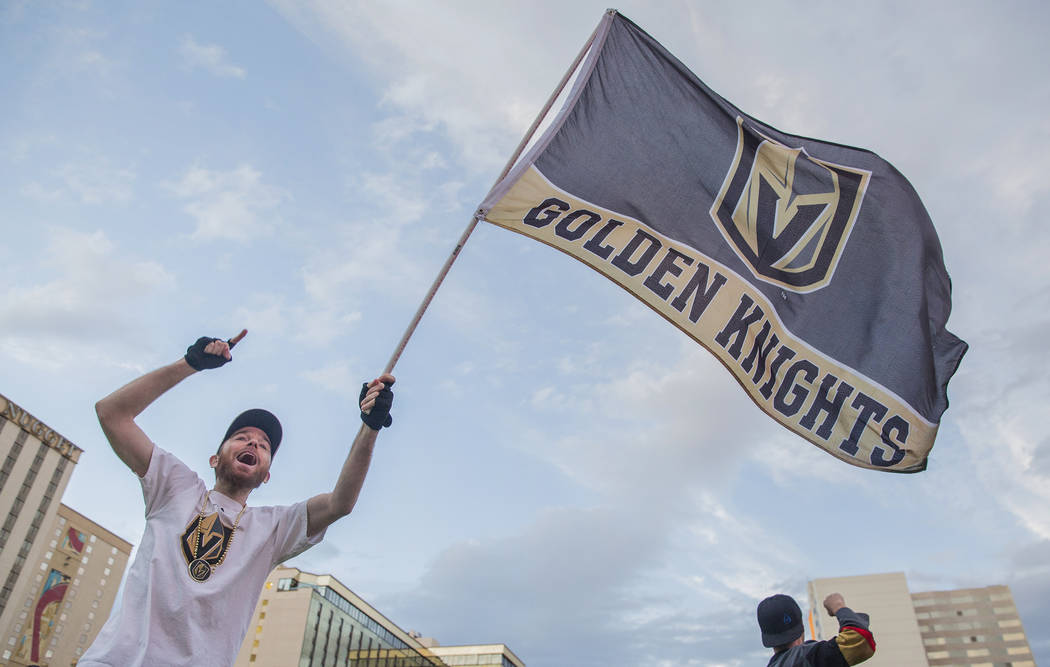 Golden Knights fan Matt Helfst waves his team's flag at a watch party during game three of Vegas' playoff series with the San Jose Sharks on Monday, April 30, 2018, at Downtown Las Vegas Events Ce ...
