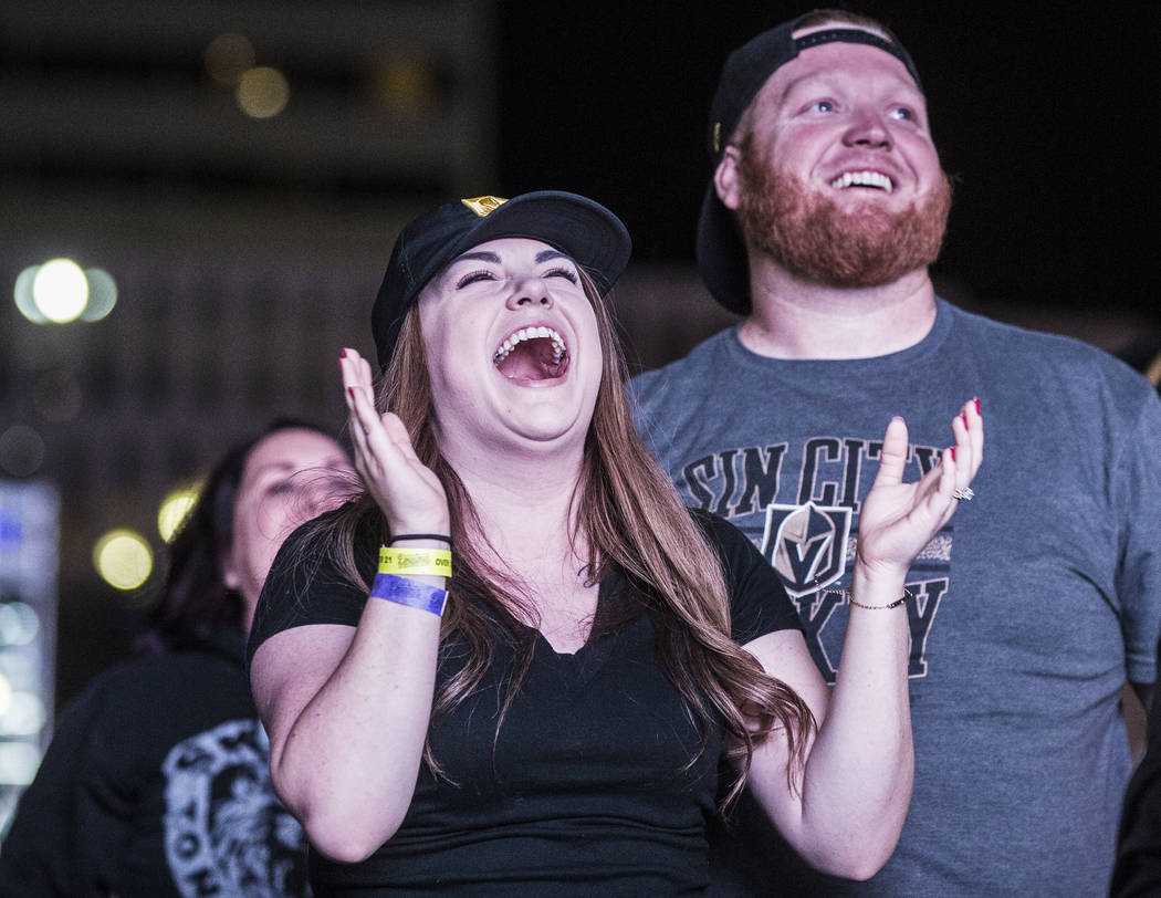 Golden Knights fan Kelly Lange, left, celebrates after a second period goal at a watch party during game three of Vegas' playoff series with the San Jose Sharks on Monday, April 30, 2018, at Downt ...