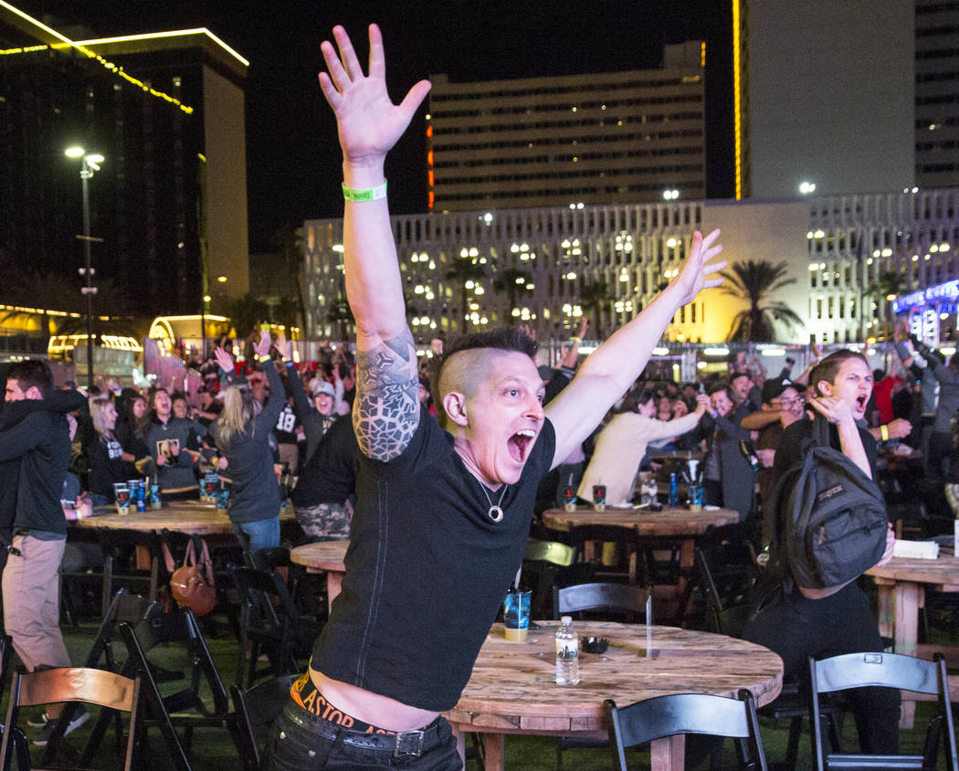 Golden Knights fan Billy Kesner, middle, celebrates at a watch party after Vegas' Jonathan Marchessault scored an overtime goal to beat the San Jose Sharks 4-3 during game three of Vegas' playoff ...