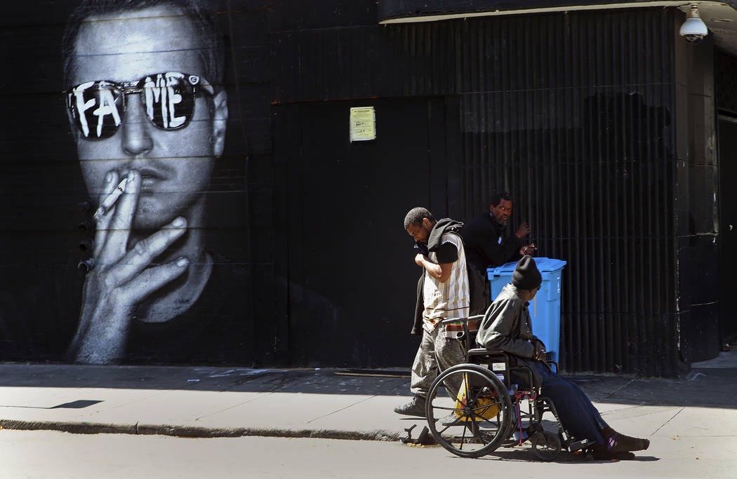 In this photo taken on Thursday, April 26, 2018, men meet on a street corner in San Francisco. San Francisco may have hit peak saturation with tent camps, stinky urine and trash littering its filt ...
