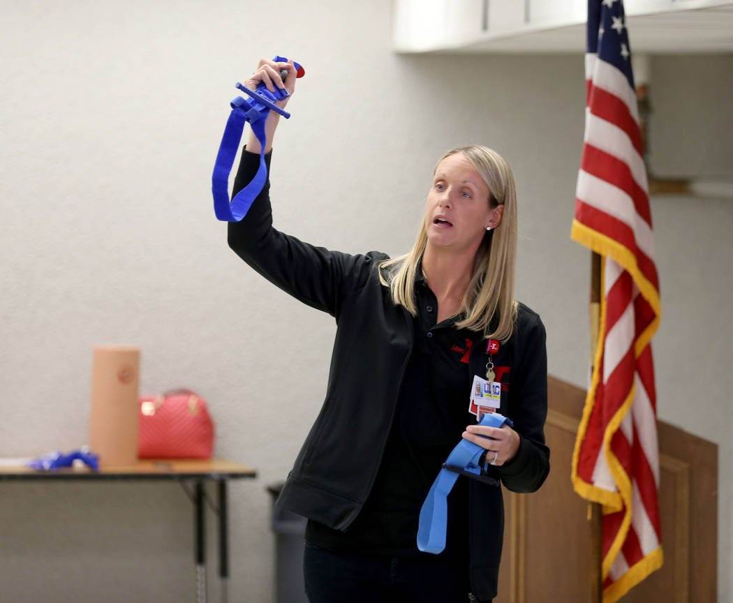 University Medical Center Trauma Outreach and Injury Prevention Program Coordinator Cassandra Trummel shows different tourniquets during "Stop the Bleed" training for teachers and staff ...