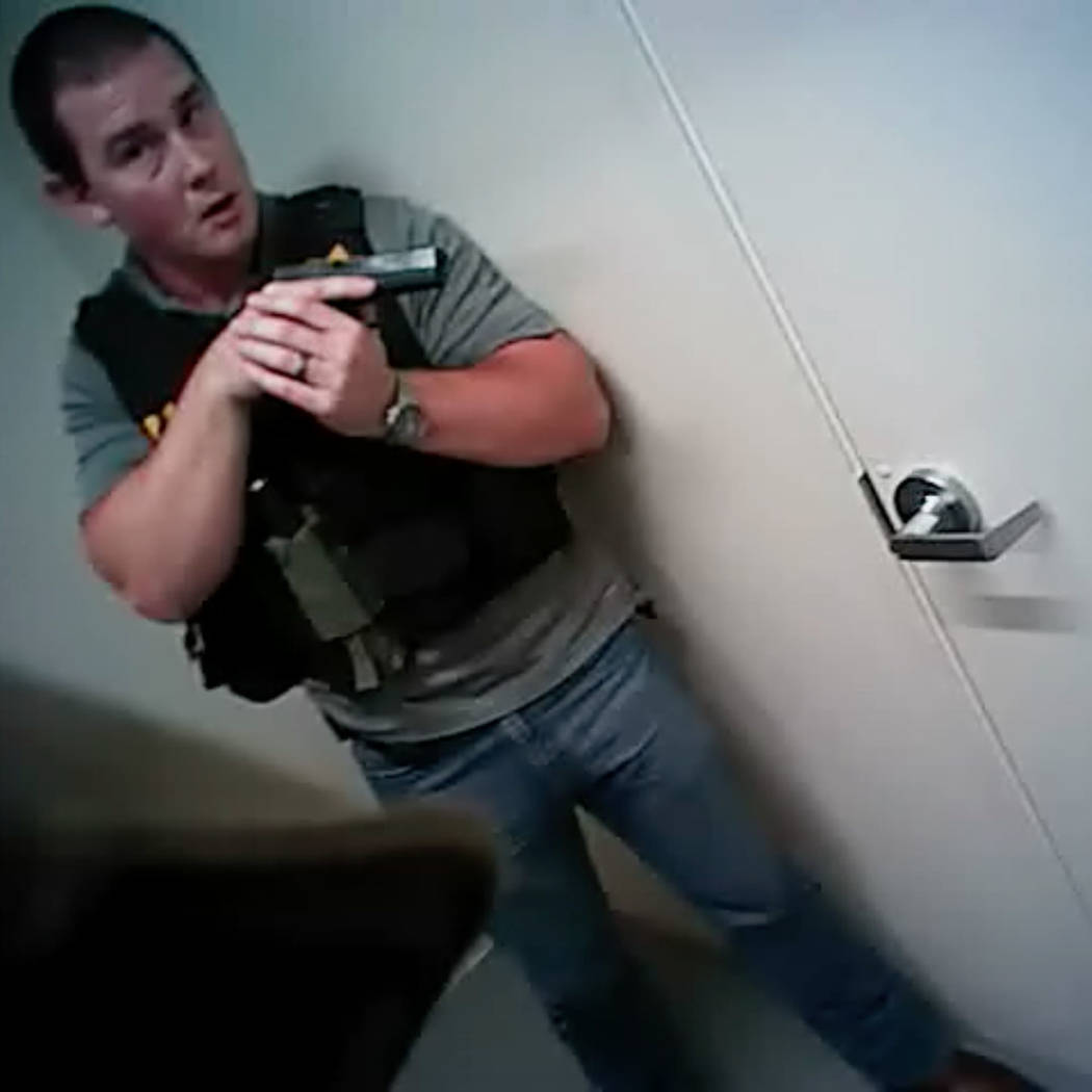 This screen grab from body camera footage released by Las Vegas police, Wednesday, May 2, 2018, shows the moment officers breached the Oct. 1 gunman's Mandalay Bay suite. Metropolitan Police Depar ...