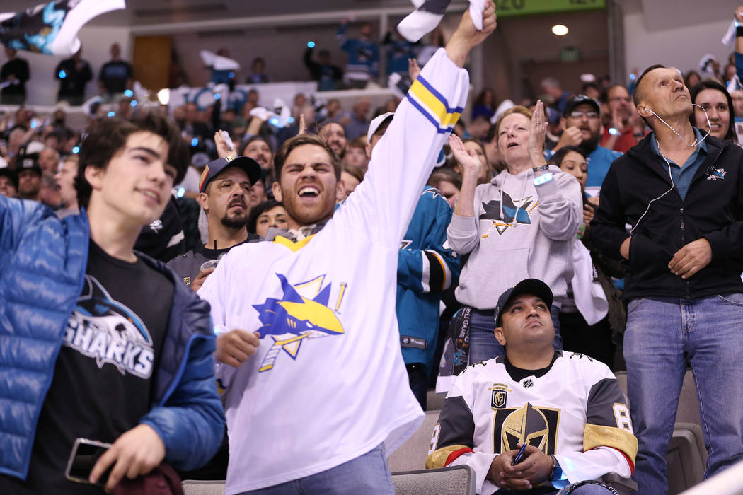 Fans celebrate a score by the San Jose Sharks against the Vegas Golden Knights during the first period in Game 4 of an NHL hockey second-round playoff series at the SAP Center in San Jose, Calif, ...