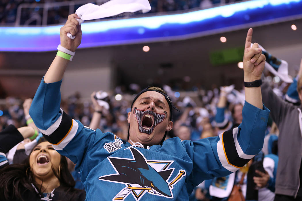 Marco Rodriguez, center, with his girlfriend Liliana Gomez, left, celebrate a score by the San Jose Sharks during the first period in Game 4 of an NHL hockey second-round playoff series at the SAP ...