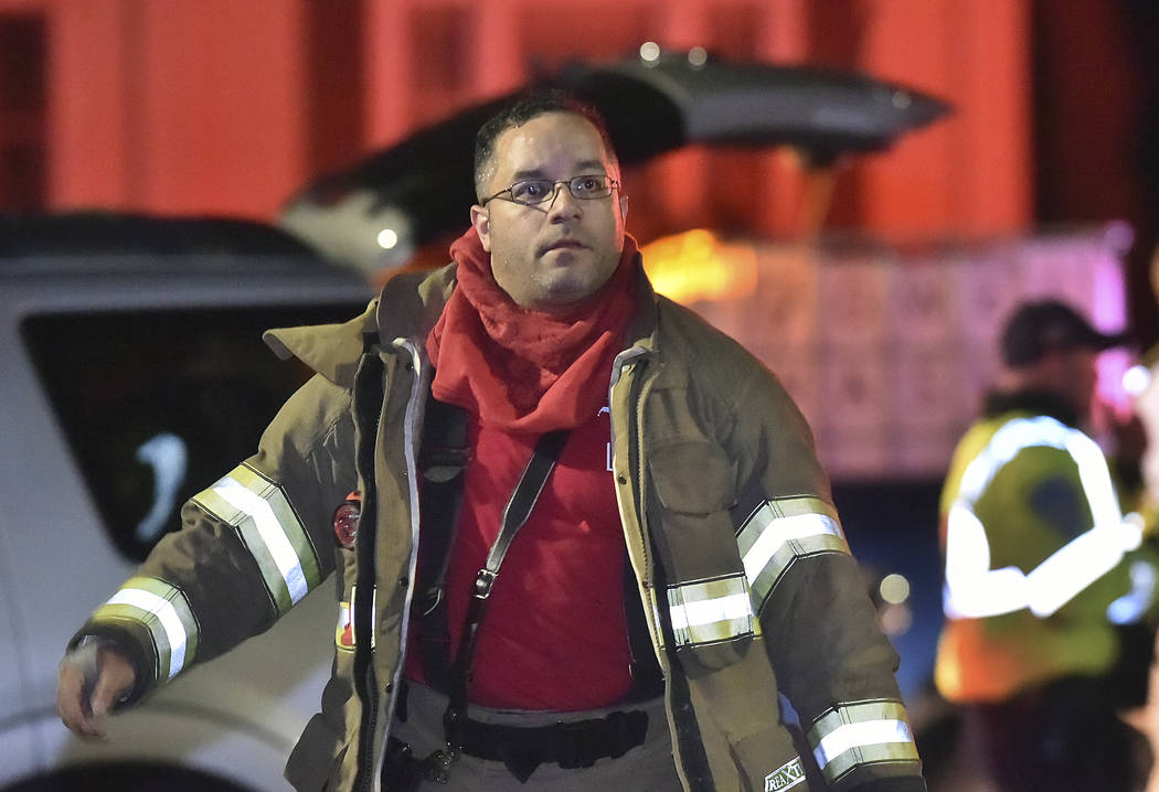 Emergency personnel walk near the scene of explosion and reported stand-off Wednesday, May 2, 2018 in North Haven, Conn. A house in Connecticut has exploded while police and a SWAT team were outsi ...