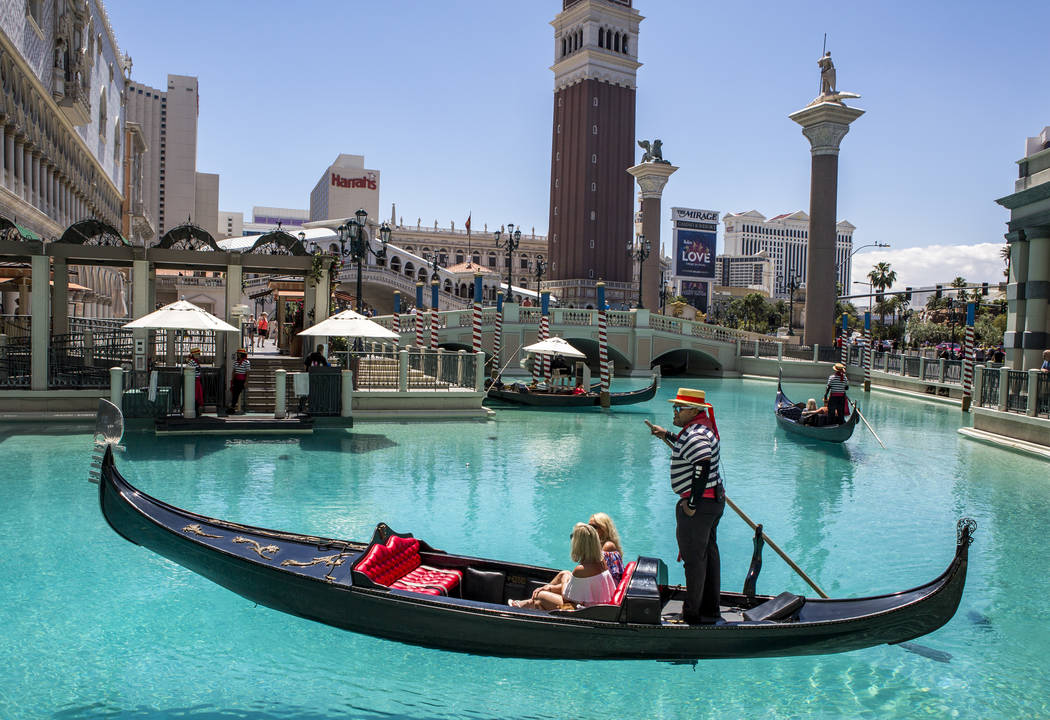 Golden Knights national anthem singer Carnell Johnson, also known as "Golden Pipes," takes Rani Spokes and Bree Hooper of Australia for a gondola ride outside the Venetian in Las Vegas o ...
