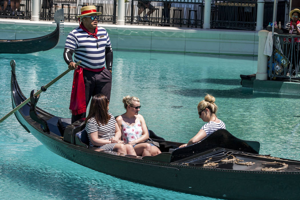 Golden Knights national anthem singer Carnell Johnson, also known as "Golden Pipes," takes Scottish visitors, from left, Michelle Brooks, Natasha Anderson and Alexandra Orr for a gondola ...