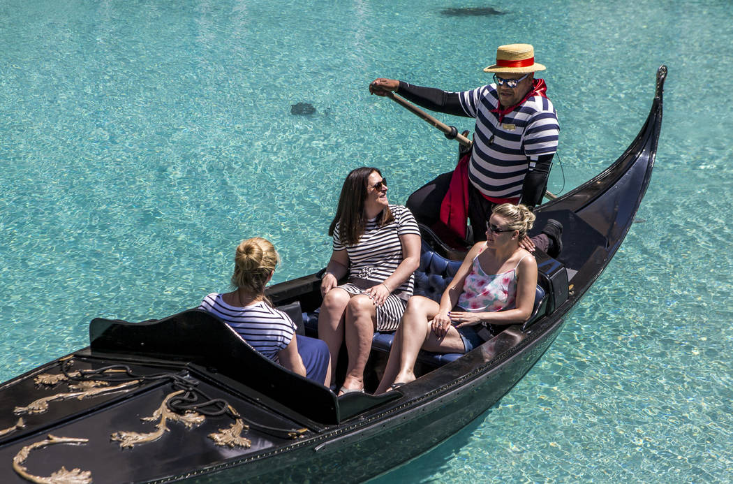 Golden Knights national anthem singer Carnell Johnson, also known as "Golden Pipes," takes Scottish visitors, from left, Alexandra Orr, Michelle Brooks and Natasha Anderson for a gondola ...