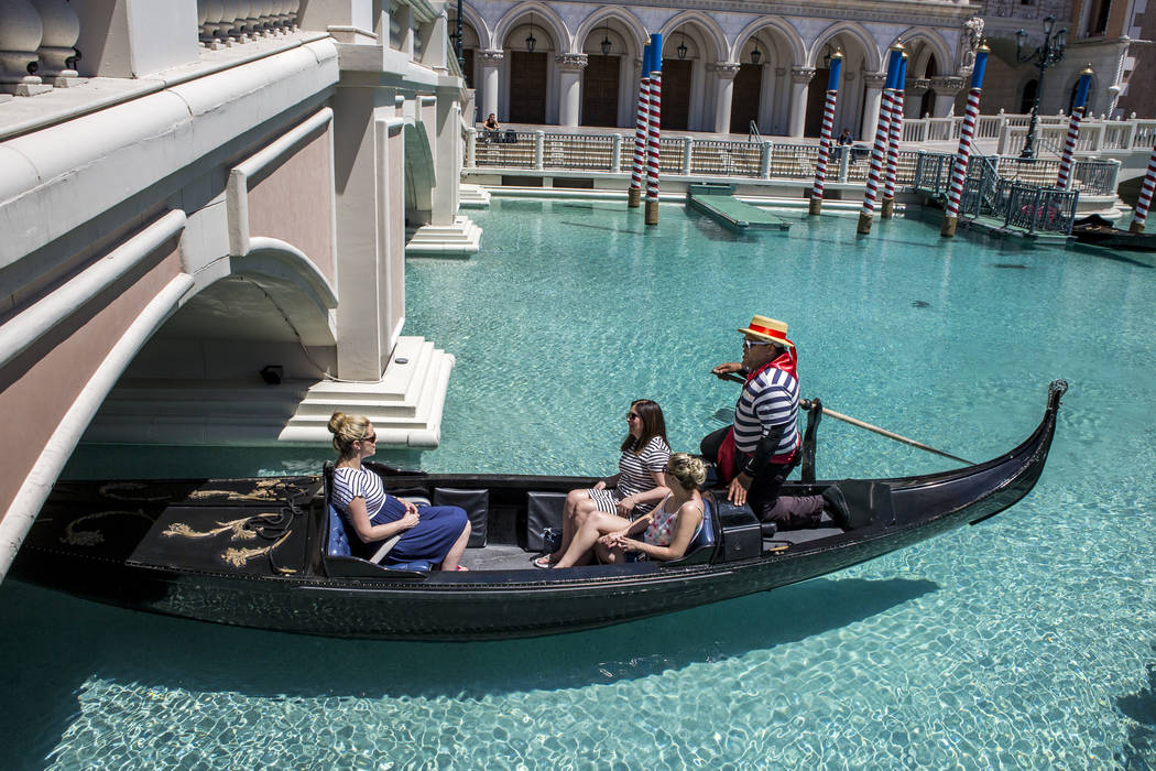 Golden Knights national anthem singer Carnell Johnson, also known as "Golden Pipes," takes Scottish visitors, from left, Alexandra Orr, Michelle Brooks and Natasha Anderson for a gondola ...