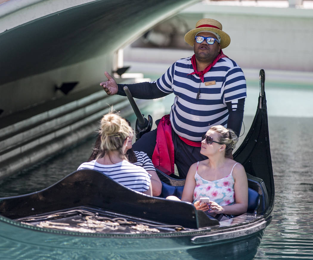 Golden Knights national anthem singer Carnell Johnson, also known as "Golden Pipes," takes Scottish visitors, from left, Alexandra Orr, Michelle Brooks and Natasha Anderson for a gondola ...