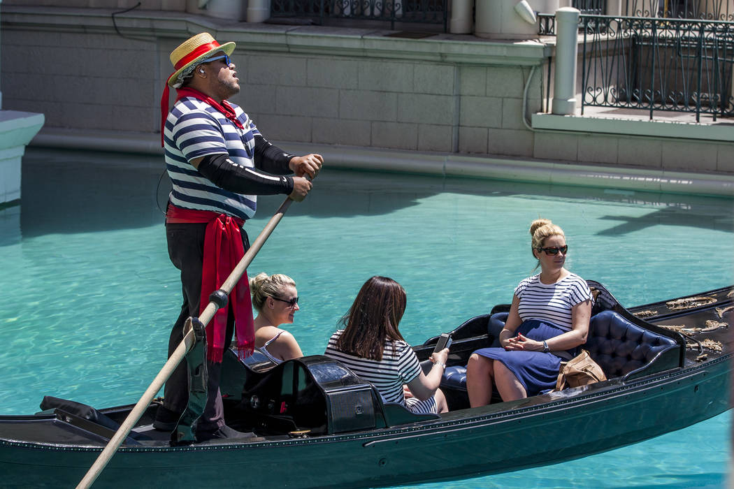 Golden Knights national anthem singer Carnell Johnson, also known as "Golden Pipes," takes Scottish visitors, from left, Natasha Anderson, Michelle Brooks and Alexandra Orr for a gondola ...