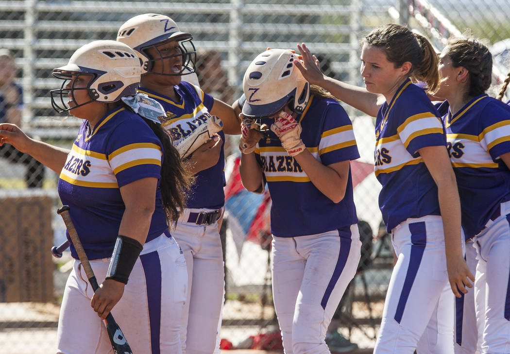 Durango players pat Kaitlin Fazendin on the helmet after she scored a two-run home run and also brought Madisyn Conriquez home while playing against Durango in the third inning at Desert Oasis Hig ...