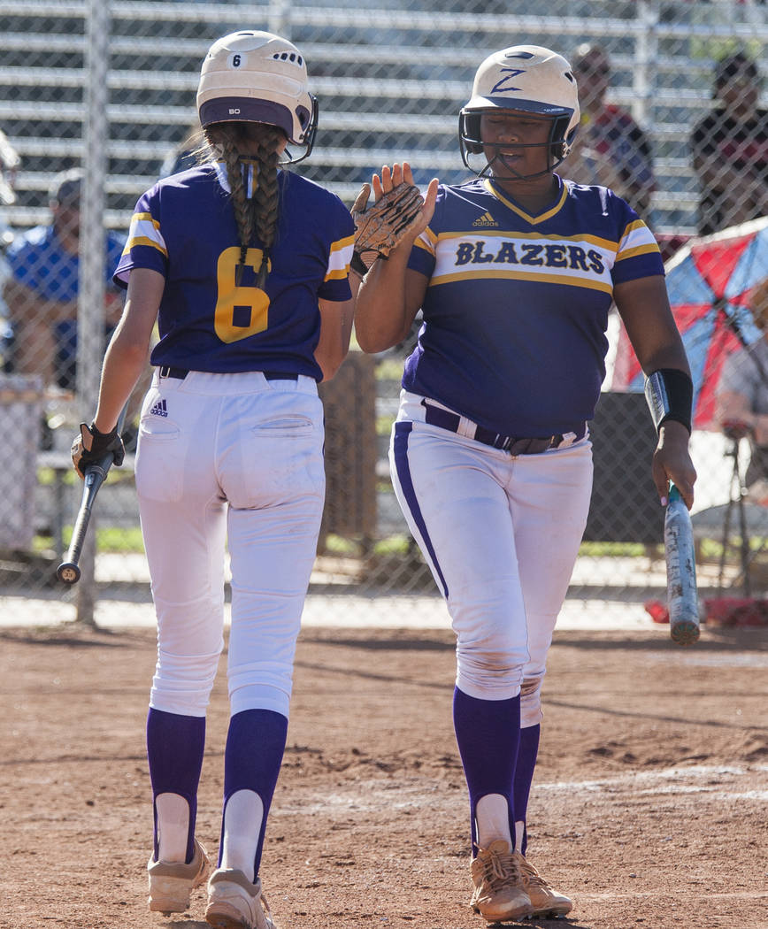 Durango infielder Madison Boyce, left, high fives pitcher Trinity Valentine after Valentine scored in the fourth inning against Desert Oasis at Desert Oasis High School in Las Vegas on Thursday, M ...