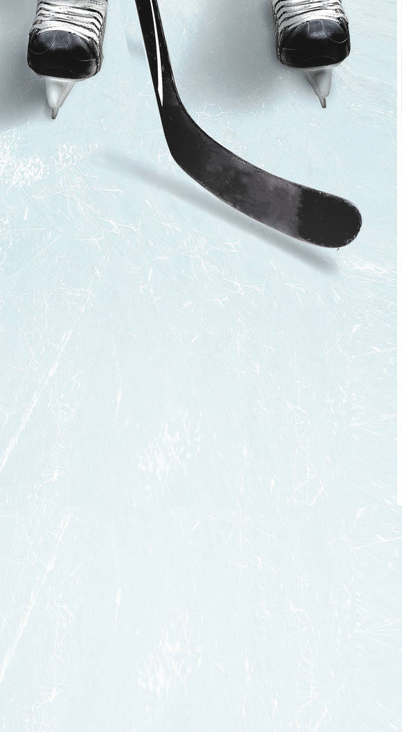 Hockey stick and puck on ice with a player's skates showing partically and copy space. Vertical orientation.