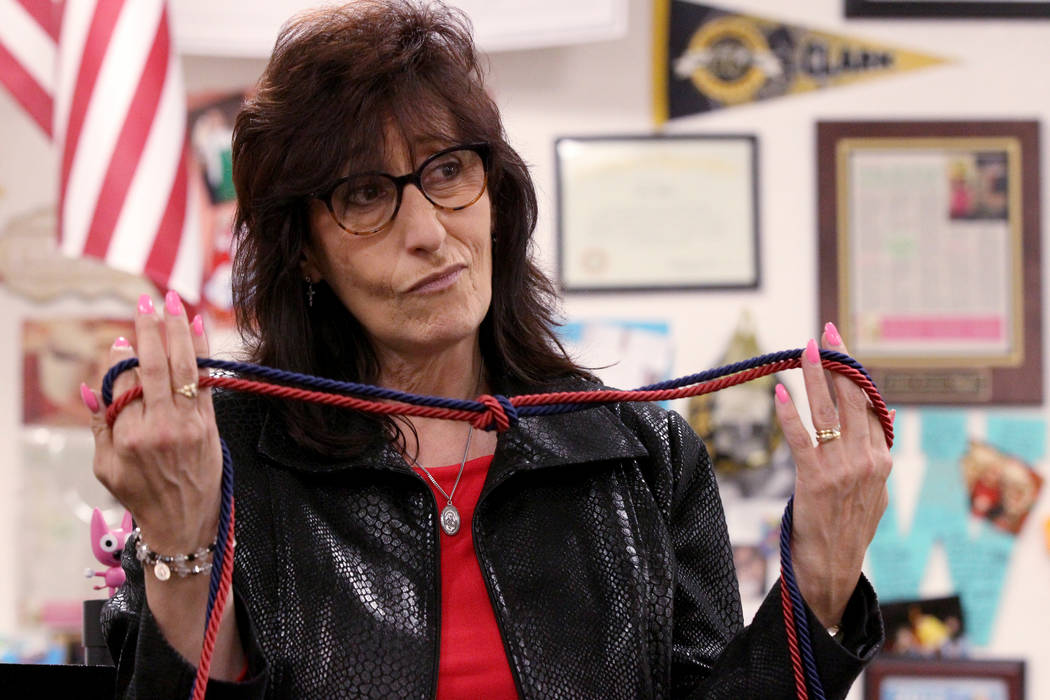 Clark High School teacher Luanne Wagner shows a graduation cord during a meeting of the KEEN Club Wednesday, May 2, 2018. Wagner is the club advisor for Keeping Everyone's Eyes on the Neighborhood ...