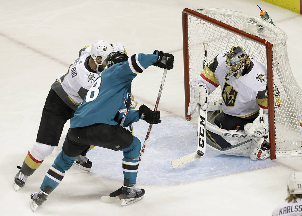 Vegas Golden Knights goaltender Marc-Andre Fleury, right, defends a shot from San Jose Sharks center Tomas Hertl, from the Czech Republic, during Game 4 of an NHL hockey second-round playoff serie ...
