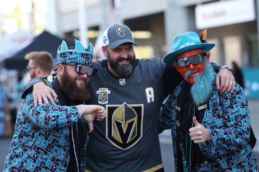 San Jose Sharks fans Rick Cady, left, and Anthony Mattos, right, take a photo with Vegas Golden Knights fan Wolfgang Gastner before Game 4 of an NHL hockey second-round playoff series at the SAP C ...