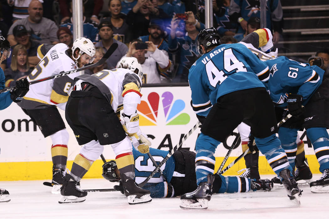 San Jose Sharks center Eric Fehr (16) hits the ground as his team and Vegas Golden Knights players look for the puck during the first period in Game 6 of an NHL hockey second-round playoff series ...