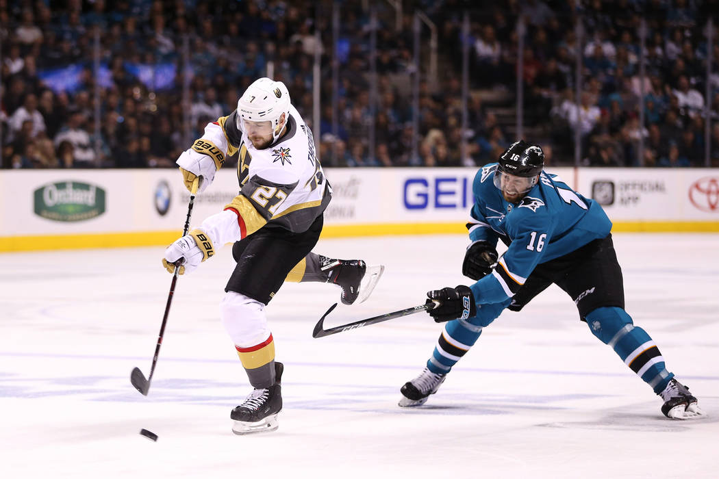 Vegas Golden Knights defenseman Shea Theodore (27) takes a shot under pressure from San Jose Sharks center Eric Fehr (16) during the second period in Game 6 of an NHL hockey second-round playoff s ...