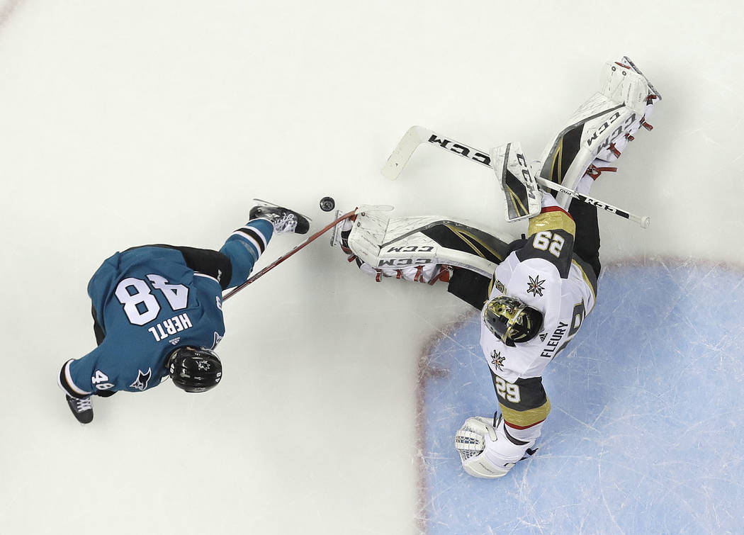 Vegas Golden Knights goaltender Marc-Andre Fleury, right, stops a shot by San Jose Sharks center Tomas Hertl during the second period of Game 6 of an NHL hockey second-round playoff series Sunday, ...