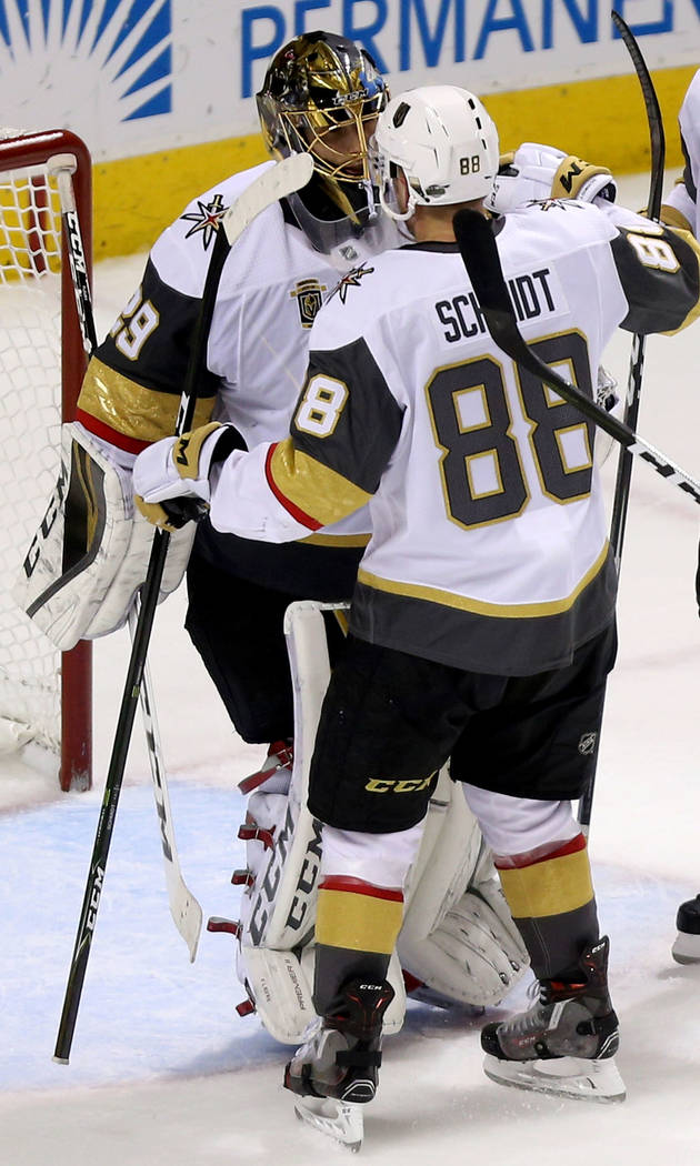 Vegas Golden Knights goaltender Marc-Andre Fleury (29) embraces defenseman Nate Schmidt (88) following their win in Game 6 of an NHL hockey second-round playoff series at the SAP Center in San Jos ...