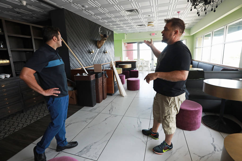 Scott Commings, left, and Antonio Nunez talk about the set up at The Stove, which will offer a main dining room, a Coffee Chill room and a Twisted Tea Room, in Henderson, Nevada on Sunday, May 6, ...