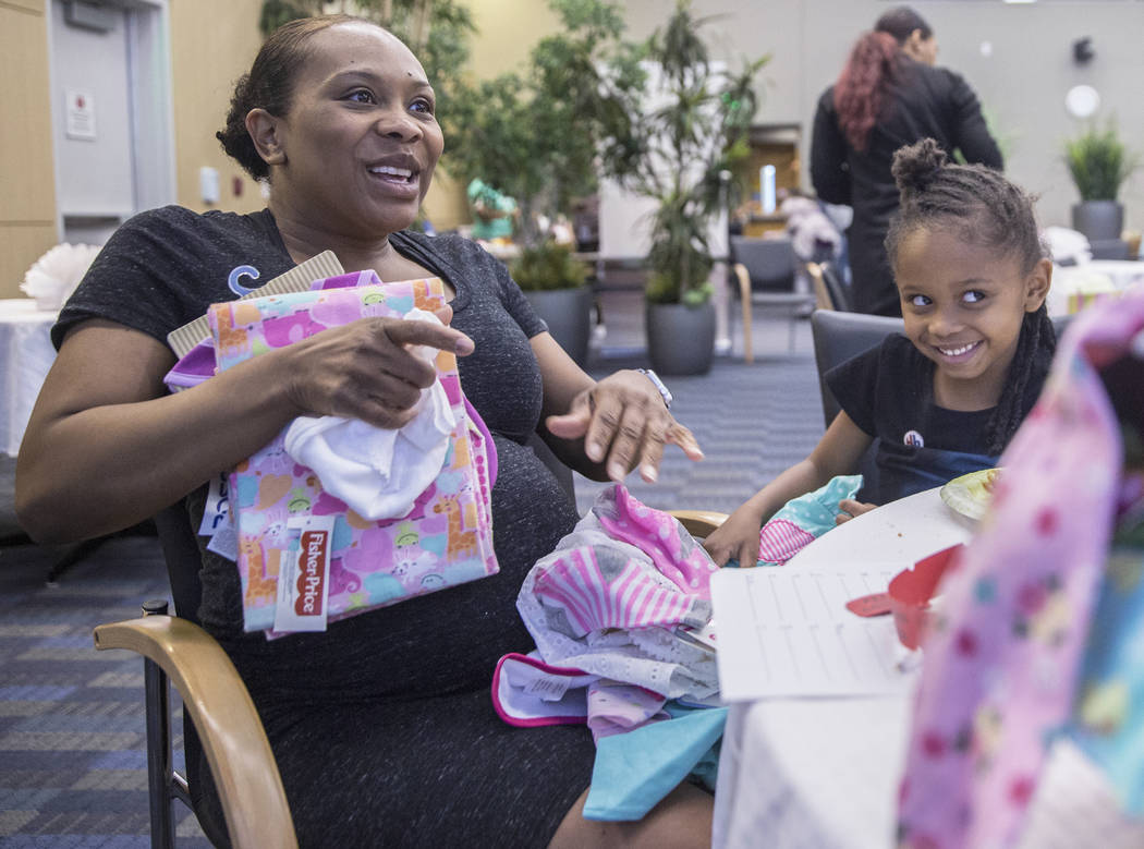 Yasmeen Donahue, left, and daughter Alexandria listen for their raffle number during a baby shower sponsored by the Veteran's Affairs Southern Nevada Healthcare System in partnership with the Eliz ...