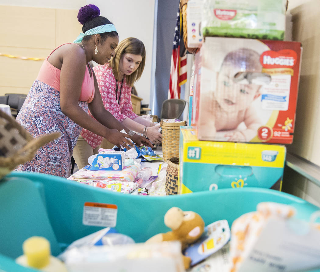 Aleesha Williams, left, grabs a bag of diapers during a baby shower sponsored by the Veteran's Affairs Southern Nevada Healthcare System in partnership with the Elizabeth Dole Foundation on Monday ...
