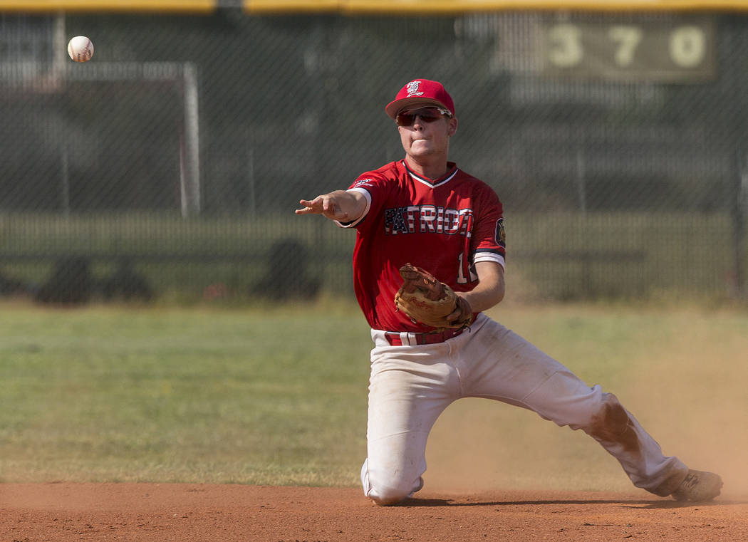 Liberty second baseman Tyler Williamson (12) makes a sliding stop in the first inning during the Patriots home matchup with Coronado High School during the opening round of the Sunrise Region base ...