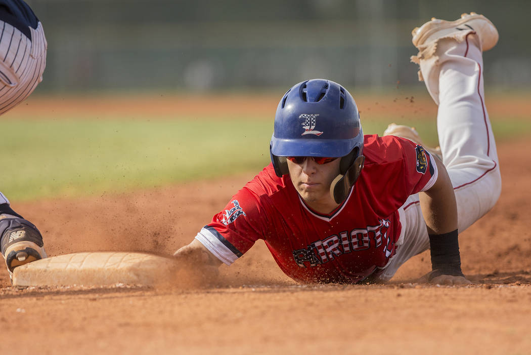 Liberty's Joseph Rush (2) slides in safely past Coronado's Boston Mabeus (23) in third inning during the Patriots home matchup with the Cougars during the opening round of the Sunrise Region baseb ...
