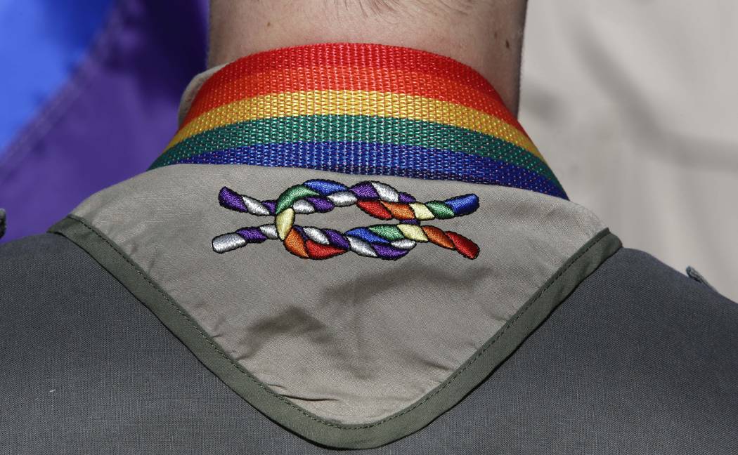 In this June 8, 2014, file photo, a Boy Scout wears his kerchief embroidered with a rainbow knot during Salt Lake City's annual gay pride parade. An announcement Tuesday night, May 8, 2018, by The ...