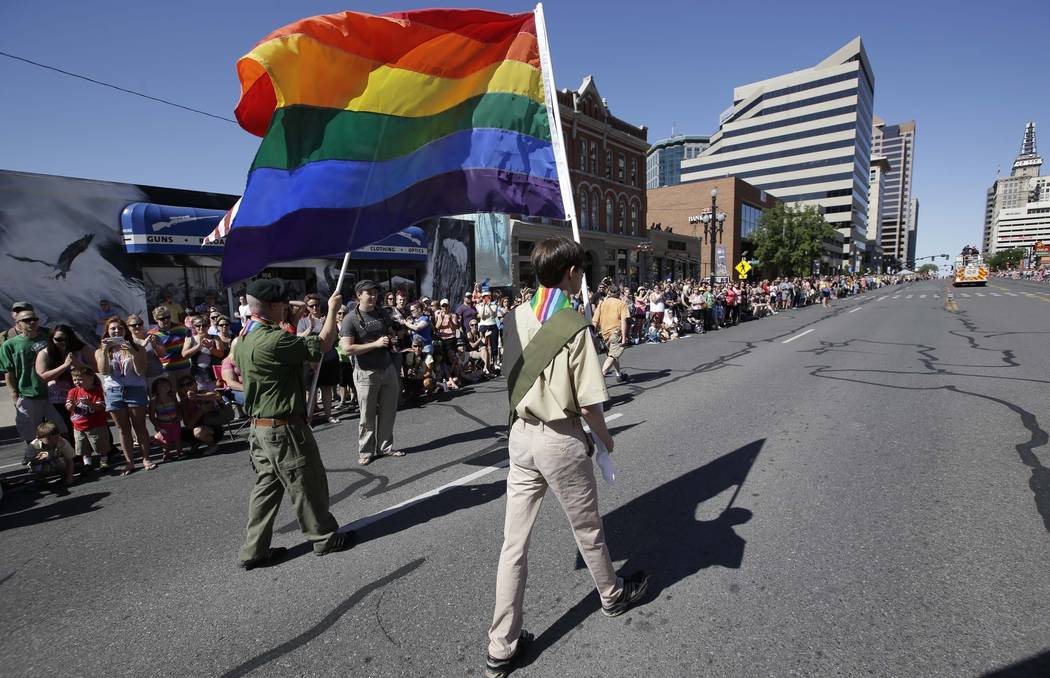 In this June 8, 2014, file photo, a group of Boy Scouts march during the Salt Lake City's annual gay pride parade in Salt Lake City. An announcement Tuesday night, May 8, 2018, by The Church of Je ...