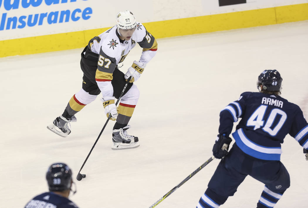 Vegas Golden Knights left wing David Perron (57) looks for a pass as Winnipeg Jets right wing Joel Armia (40) closes in during the second period in Game 1 of an NHL hockey third-round playoff seri ...