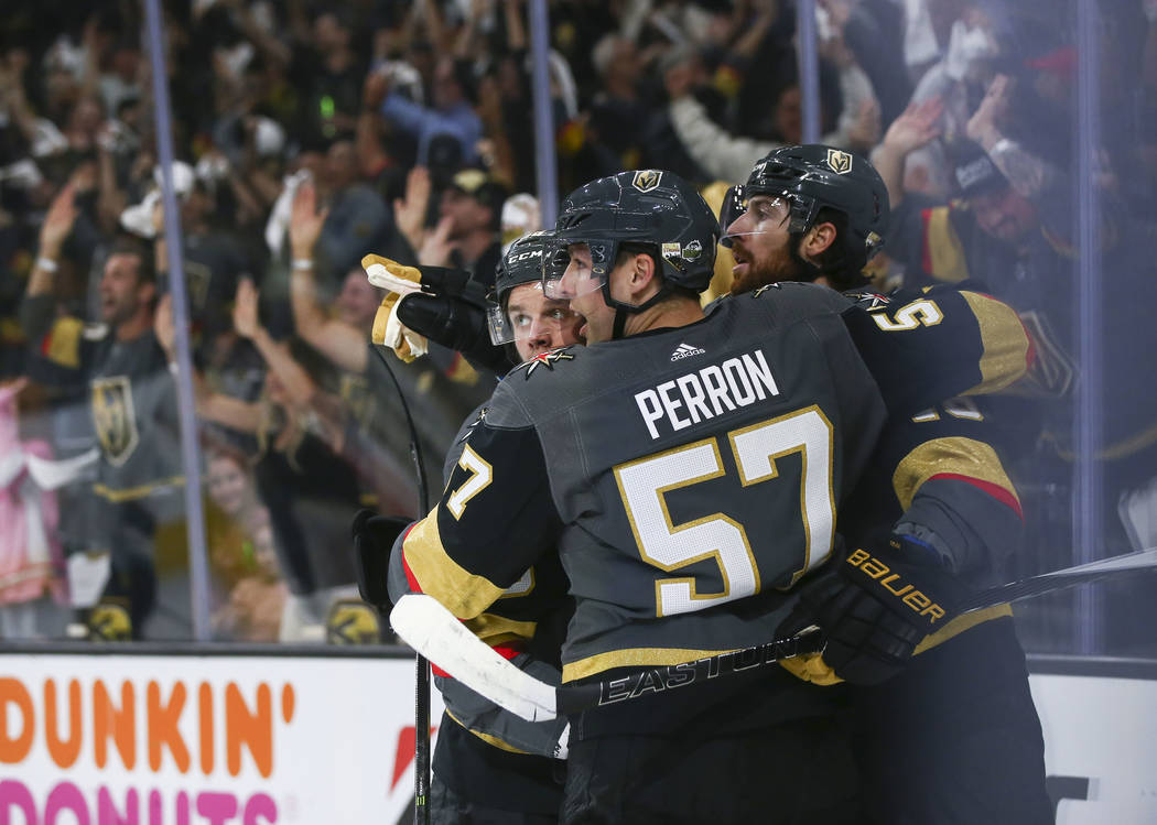 Golden Knights players, from left, Erik Haula, David Perron (57) and James Neal (18) celebrate a goal against the San Jose Sharks by Neal during the first period of Game 5 of an NHL hockey second- ...