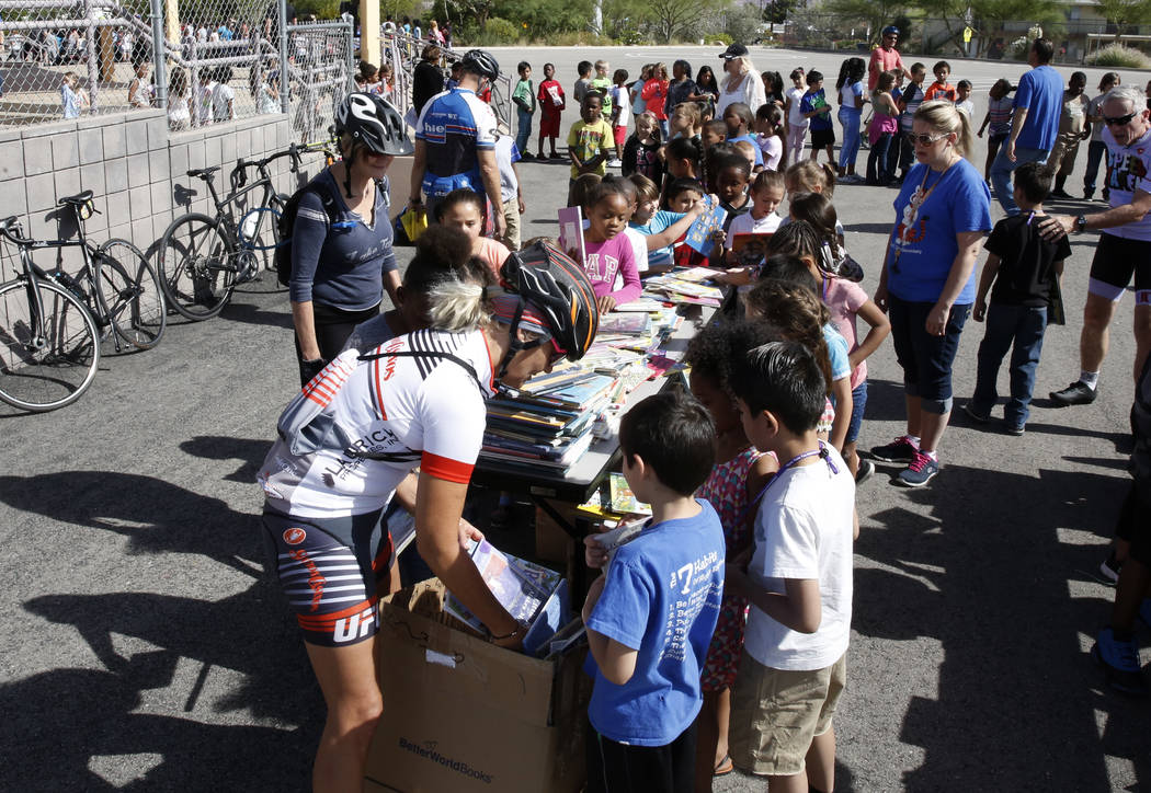 Kristie Peressini, left, helps Robert L. Taylor Elementary School students select their books during the eighth annual “Ride for Reading” event on Friday, May 11, 2018, in Henderson. ...