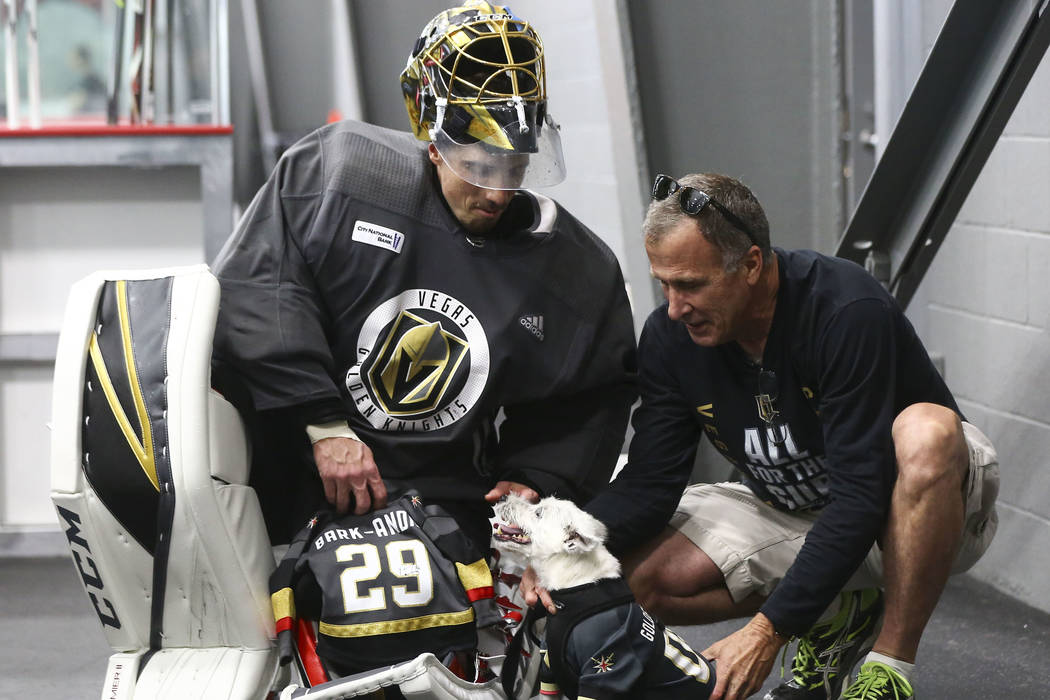 Golden Knights goaltender Marc-Andre Fleury (29) meets Bark Andre-Furry, a Jack Russell terrier, and his owner, Rick Williams, after practice at City National Arena in Las Vegas on Thursday, May 1 ...