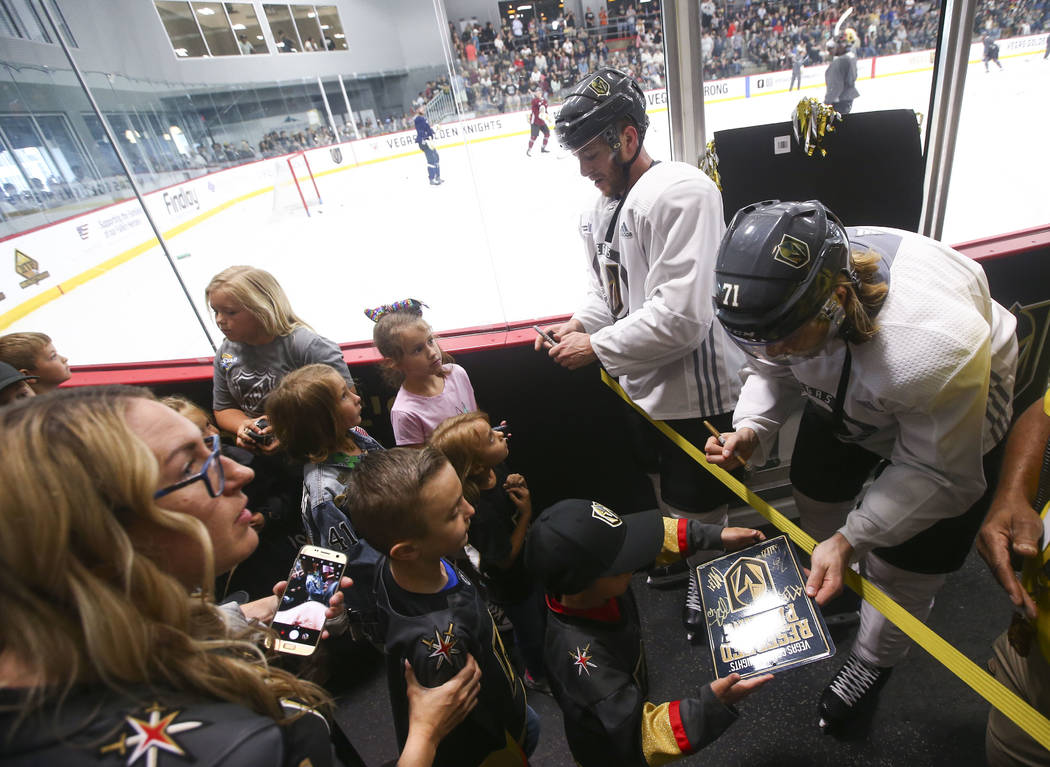 Golden Knights players Jonathan Marchessault, center right, and William Karlsson sign autographs for young fans during practice at City National Arena in Las Vegas on Thursday, May 10, 2018. Chase ...