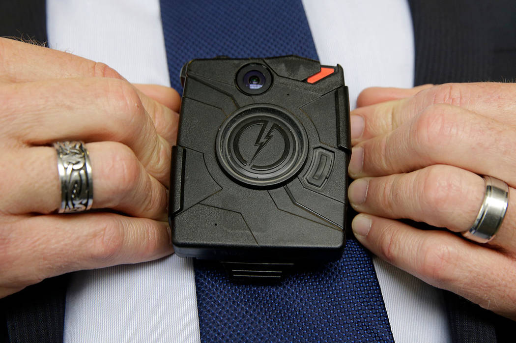 In this Feb. 19, 2015 file photo, Steve Tuttle, vice president of communications for Taser International, demonstrates one of the company's body cameras during a company-sponsored conference at th ...