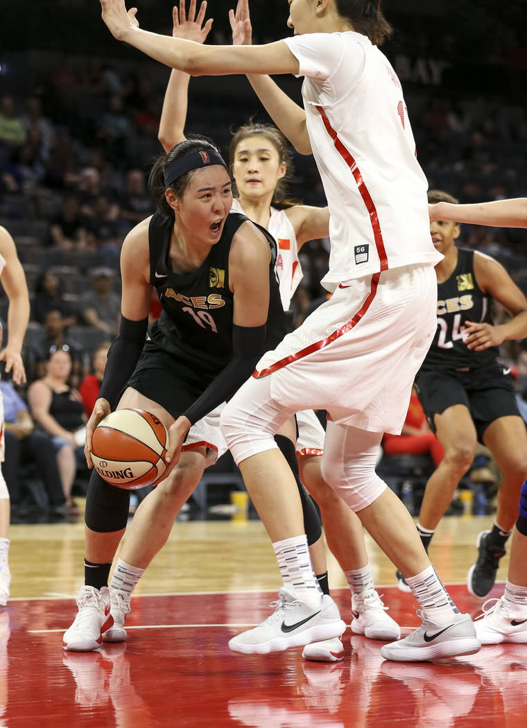 Las Vegas Aces center Ji-Su Park (19) drives the ball against China's Zhengi Pan (17) during a preseason basketball game at Mandalay Bay Events Center in Las Vegas on Sunday, May 6, 2018. Richard ...
