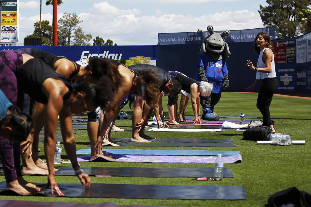 Cosmo, the Las Vegas 51s' mascot, watches yoga instructor Steph Armijo, of New York, during a Yoga on the Field event at Cashman Field in Las Vegas on Sunday, May 13, 2018. Andrea Cornejo Las Vega ...