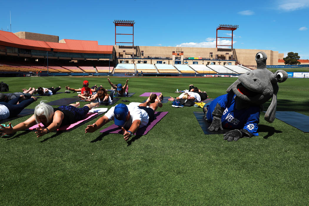 Cosmo, the Las Vegas 51s' mascot, participates in a Yoga on the Field event at Cashman Field in Las Vegas on Sunday, May 13, 2018. Andrea Cornejo Las Vegas Review-Journal @dreacornejo