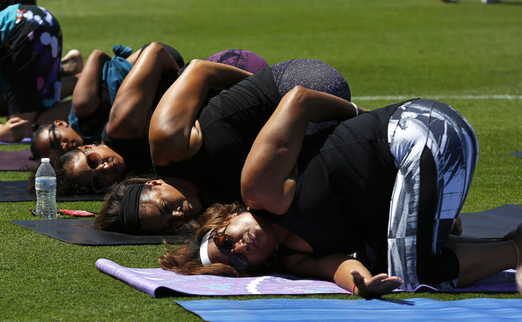 Leticia Rodriguez, of Las Vegas, right, does yoga during a Yoga on the Field event at Cashman Field in Las Vegas on Sunday, May 13, 2018. Andrea Cornejo Las Vegas Review-Journal @dreacornejo