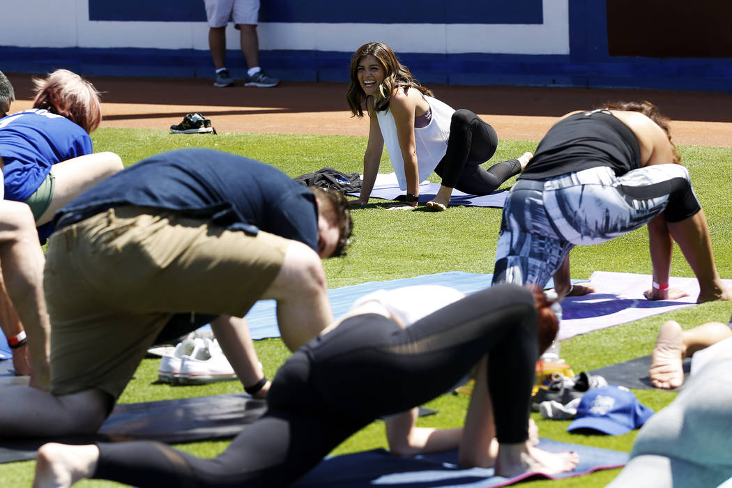 Steph Armijo, of New York, instructs a class during a Yoga on the Field event at Cashman Field in Las Vegas on Sunday, May 13, 2018. Andrea Cornejo Las Vegas Review-Journal @dreacornejo