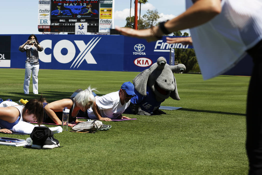 Cosmo, the Las Vegas 51s' mascot, participates in a Yoga on the Field event at Cashman Field in Las Vegas on Sunday, May 13, 2018. Andrea Cornejo Las Vegas Review-Journal @dreacornejo