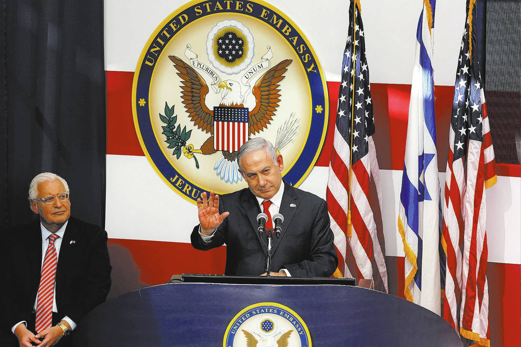 Israeli Prime Minister Benjamin Netanyahu speaks as U.S. Ambassador to Israel David Friedman listens during the opening ceremony of the new US embassy in in Jerusalem, Monday, May 14, 2018. Amid d ...