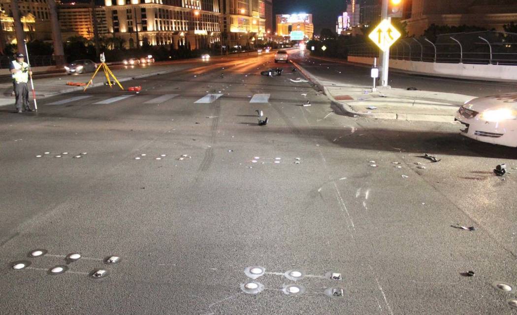 Police work the scene early Sunday morning after a 52-year-old motorcyclist died in a collision with a Cadillac pick-up truck at the northbound off-ramp from I-15 to Flamingo Road in Las Vegas. (L ...