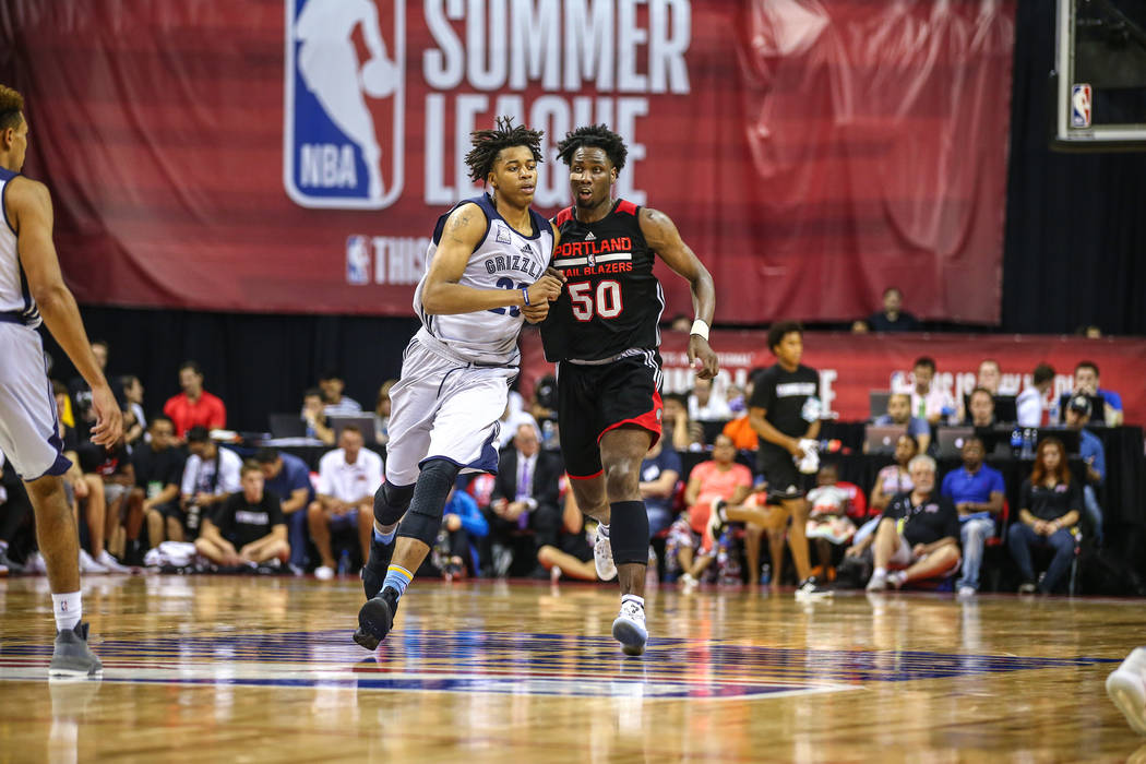 Portland Trail Blazers player Caleb Swanigan (50) competes with Memphis Grizzlies player Deyonta Davis during the NBA Summer League semifinal basketball game at Thomas and Mack Center on Sunday, J ...